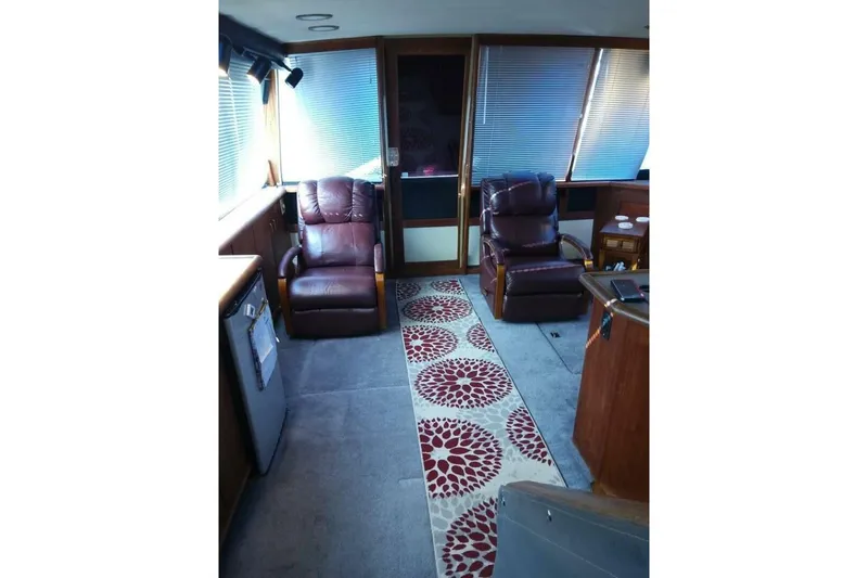 Slide: The Image of Interior of 1991 Bayliner 4588 Pilothouse with leather chairs and patterned rug. - 9