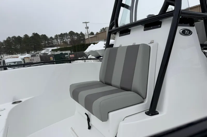 Slide: The Image of 2026 Cape Horn 22 OS boat with striped seating, outdoor setting. - 19