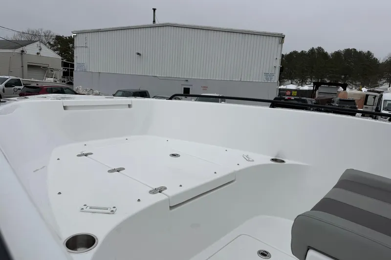 Slide: The Image of 2026 Cape Horn 22 OS boat interior with seating and storage, parked outdoors. - 20