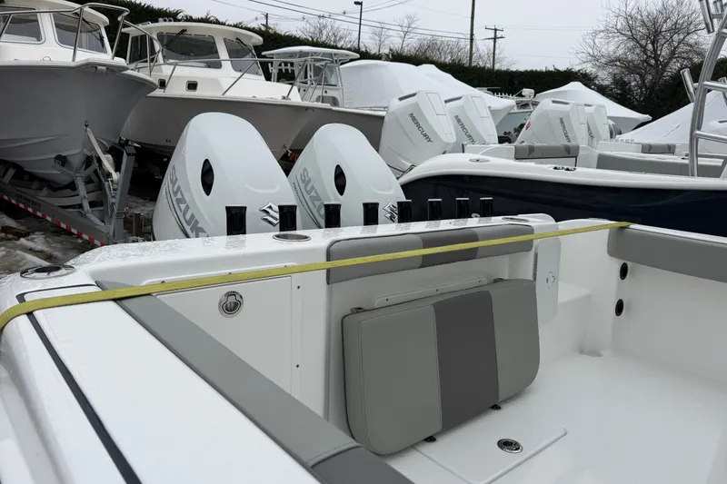 Slide: The Image of 2026 Cape Horn 22 OS boat with dual Suzuki outboard motors in a marina. - 13