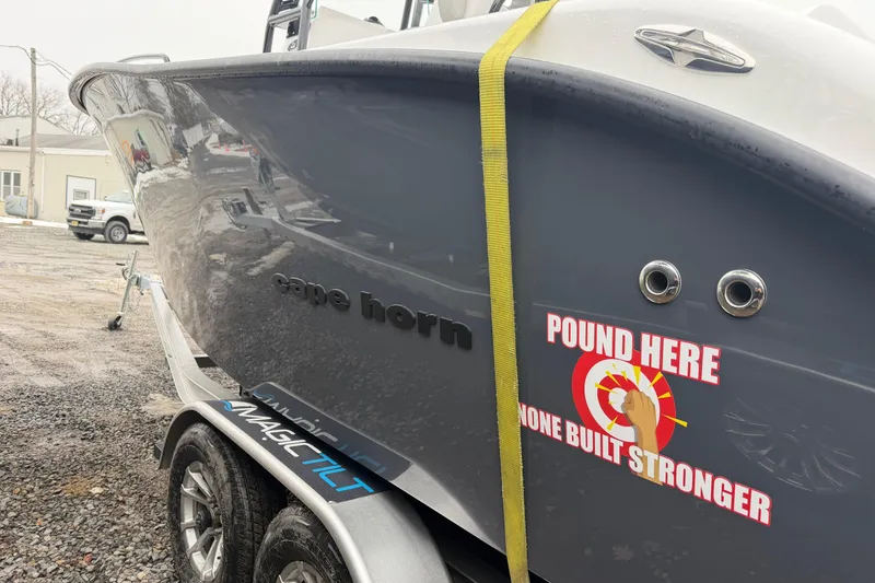 Slide: The Image of 2026 Cape Horn 22 OS boat on trailer with "Pound Here" sticker, showcasing durability. - 18