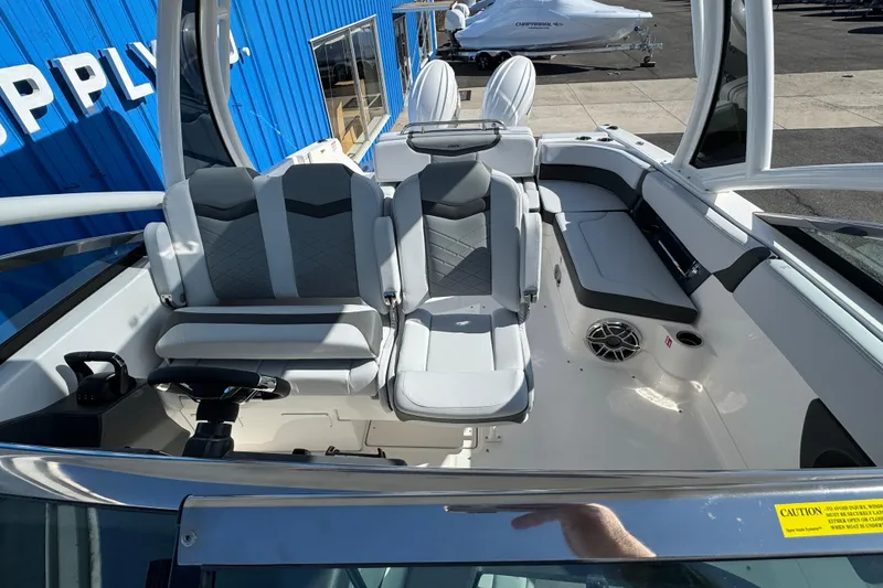Slide: The Image of 2026 Chaparral 280 OSX boat interior with modern seating and steering wheel. - 11