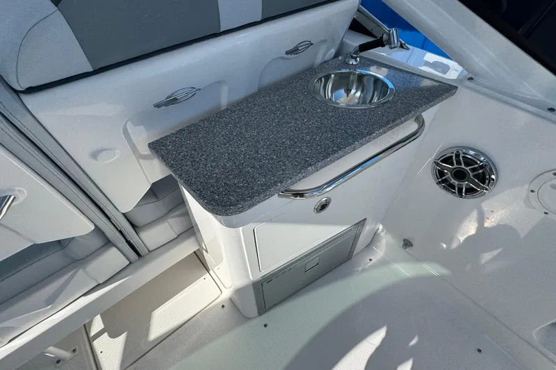 Slide: The Image of Interior of 2026 Chaparral 280 OSX boat featuring a sleek sink and countertop. - 14