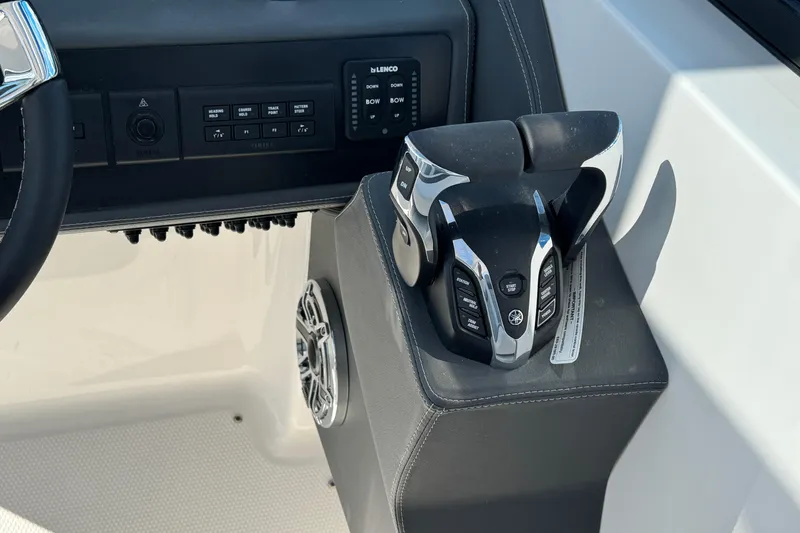 Slide: The Image of Control panel of 2026 Chaparral 280 OSX boat with steering and throttle controls. - 18