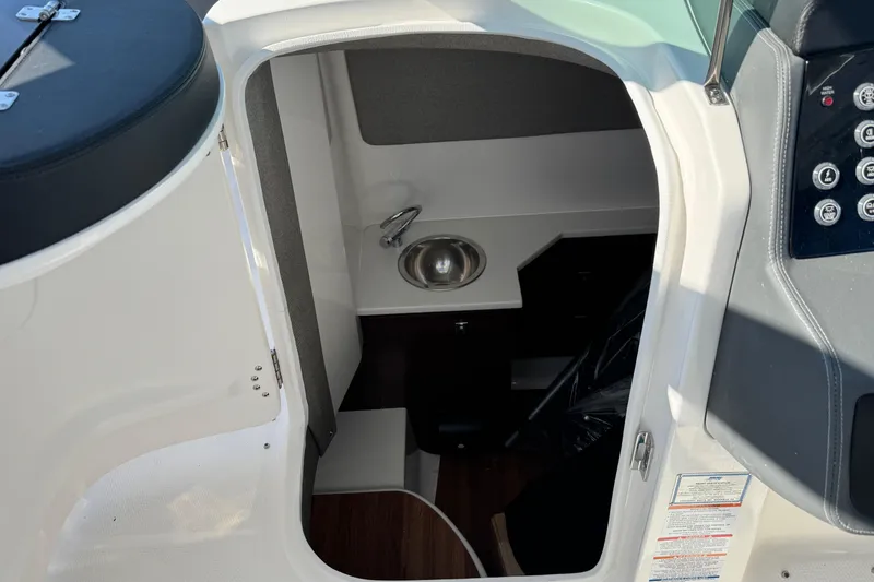 Slide: The Image of Interior cabin view of 2026 Chaparral 280 OSX boat, featuring a compact sink and control panel. - 20