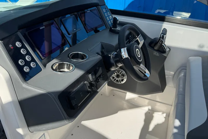 Slide: The Image of Helm of 2026 Chaparral 280 OSX boat with modern controls and displays. - 21