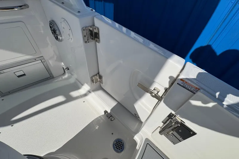 Slide: The Image of Interior view of 2026 Chaparral 280 OSX boat, featuring sleek white design and stainless steel fixtures. - 25