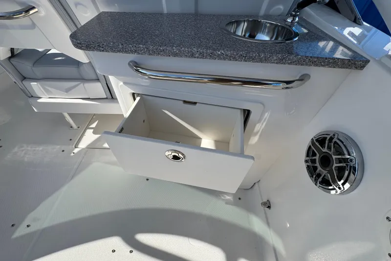 Slide: The Image of Interior of 2026 Chaparral 280 OSX boat with open drawer and sink. - 27