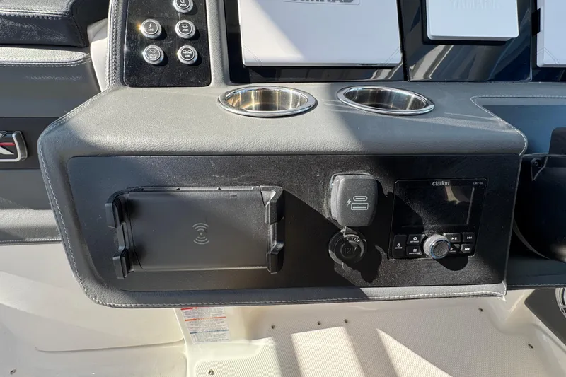 Slide: The Image of Dashboard of 2026 Chaparral 280 OSX boat with controls and cup holders. - 38
