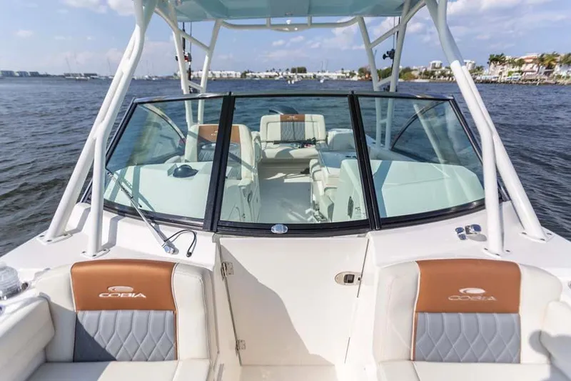 Slide: The Image of Manufacturer Provided Image: 2025 Cobia 240 Dual Console boat on water, featuring spacious seating and modern design. - 6