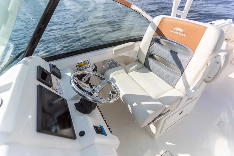 Slide: The Image of Manufacturer Provided Image: 2025 Cobia 240 Dual Console boat interior with steering wheel and comfortable seating. - 9
