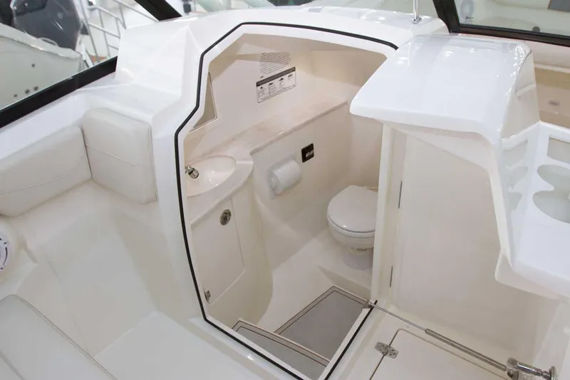 Slide: The Image of Manufacturer Provided Image: 2025 Cobia 280 Dual Console boat interior with compact bathroom amenities. - 16