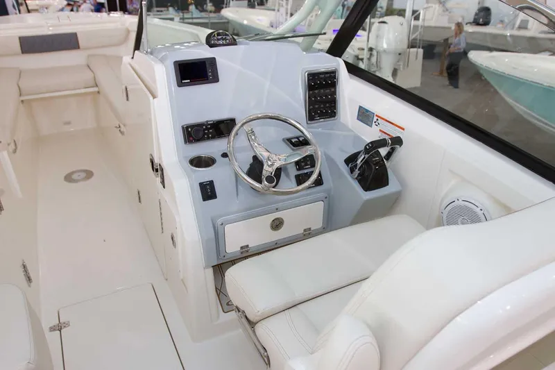 Slide: The Image of Manufacturer Provided Image: 2025 Cobia 280 Dual Console boat interior with modern helm and seating. - 9