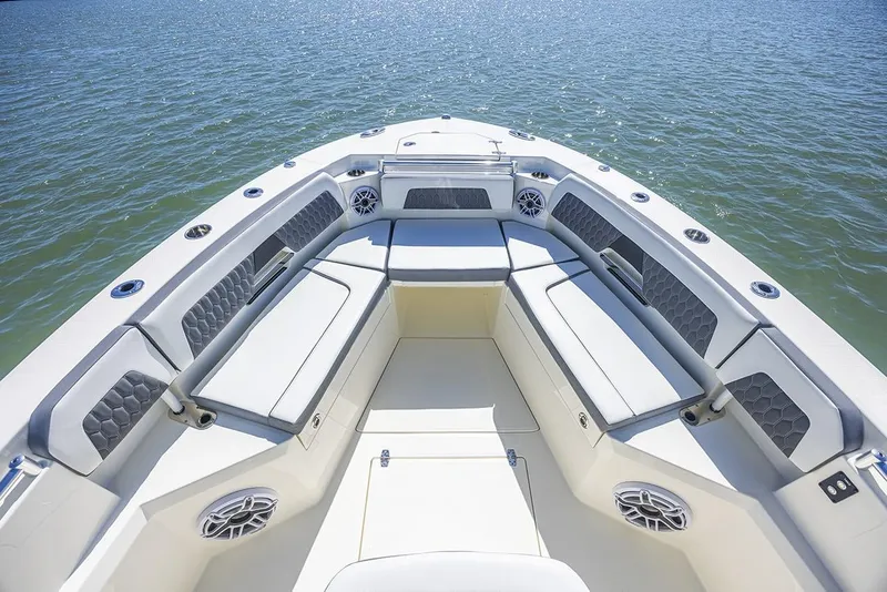 Slide: The Image of Manufacturer Provided Image: 2025 Cobia 265 Center Console boat interior with cushioned seating on calm water. - 10