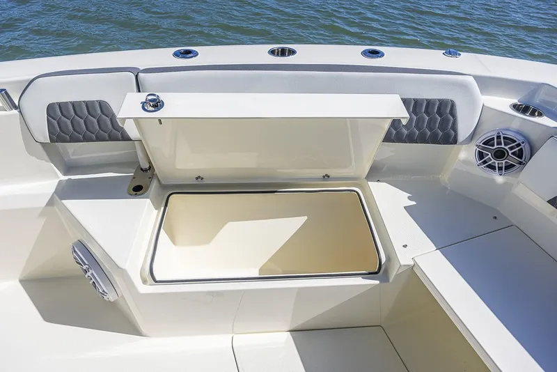 Slide: The Image of Manufacturer Provided Image: 2025 Cobia 265 Center Console boat with open storage compartment on deck. - 13