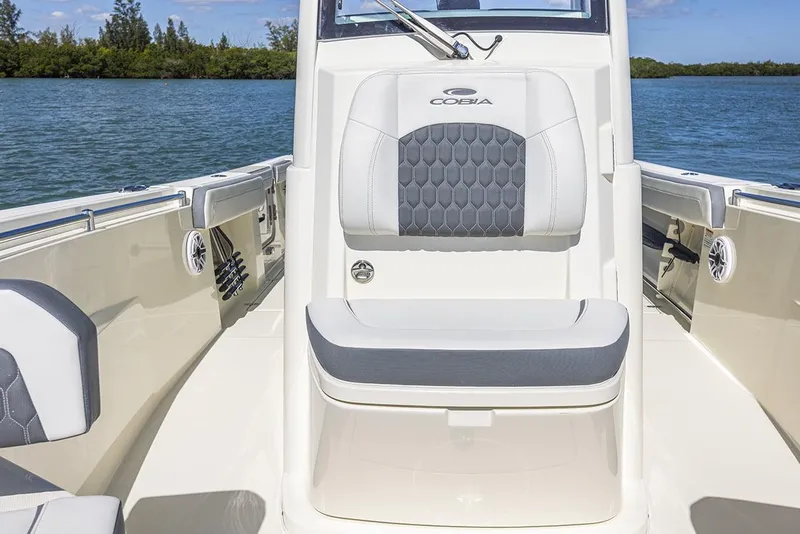 Slide: The Image of Manufacturer Provided Image: 2025 Cobia 265 Center Console boat interior with cushioned seating and water view. - 14