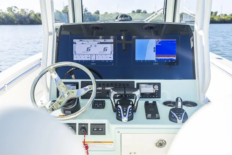 Slide: The Image of Manufacturer Provided Image: 2025 Cobia 265 Center Console boat dashboard with advanced navigation displays. - 16