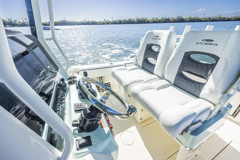 Slide: The Image of Manufacturer Provided Image: 2025 Cobia 265 Center Console boat interior with steering wheel and dual seats. - 17