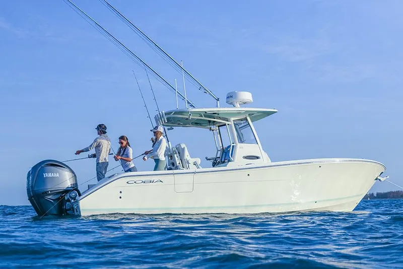Slide: The Image of Manufacturer Provided Image: 2025 Cobia 265 Center Console boat with people fishing on open water. - 3