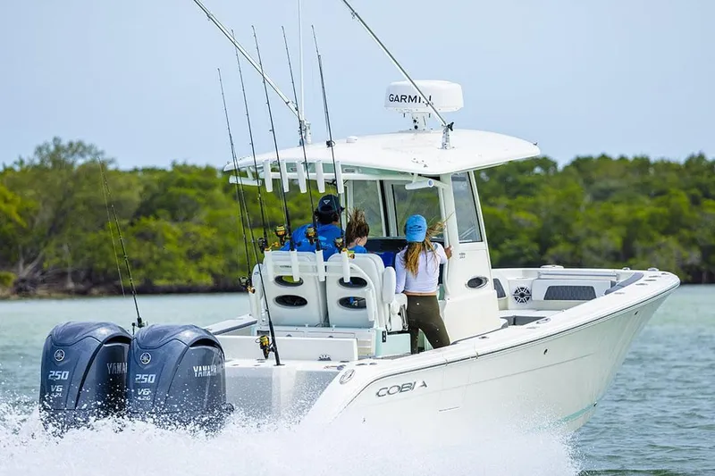 Slide: The Image of Manufacturer Provided Image: 2025 Cobia 265 Center Console boat cruising with dual Yamaha engines. - 4