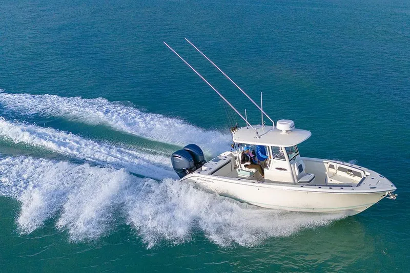 Slide: The Image of Manufacturer Provided Image: 2025 Cobia 265 Center Console boat cruising on open water. - 7