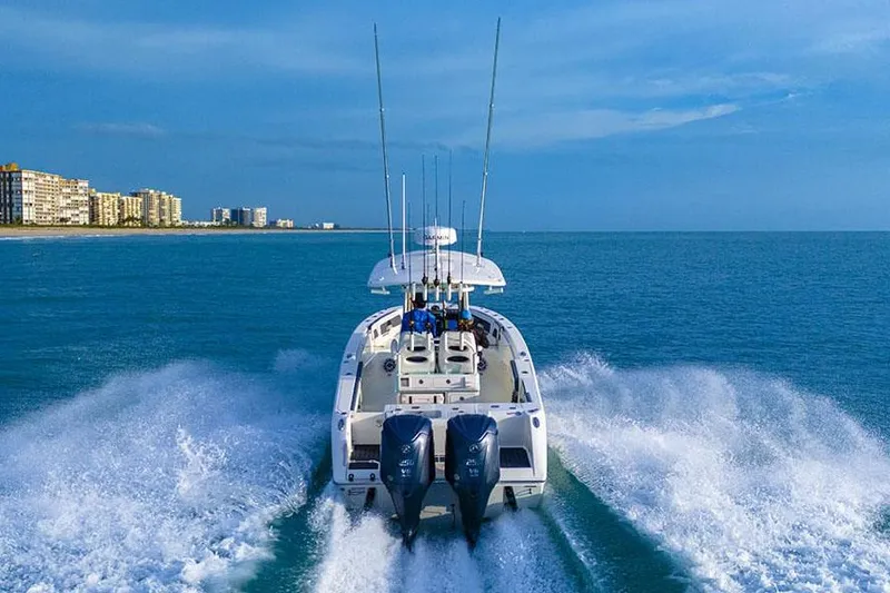 Slide: The Image of Manufacturer Provided Image: 2025 Cobia 265 Center Console boat cruising on open water. - 8
