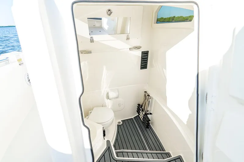Slide: The Image of Manufacturer Provided Image: 2026 Cobia 245 Center Console boat interior with toilet and storage space. - 10