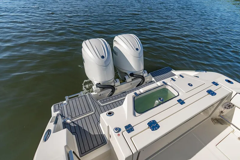 Slide: The Image of Manufacturer Provided Image: 2026 Cobia 245 Center Console boat with dual outboard motors on water. - 14