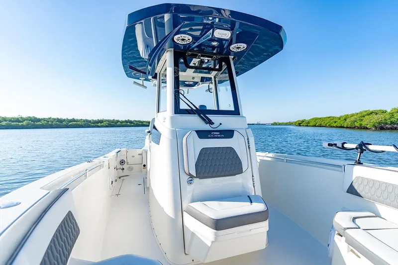 Slide: The Image of Manufacturer Provided Image: 2026 Cobia 245 Center Console boat on calm water, featuring sleek design and modern amenities. - 7