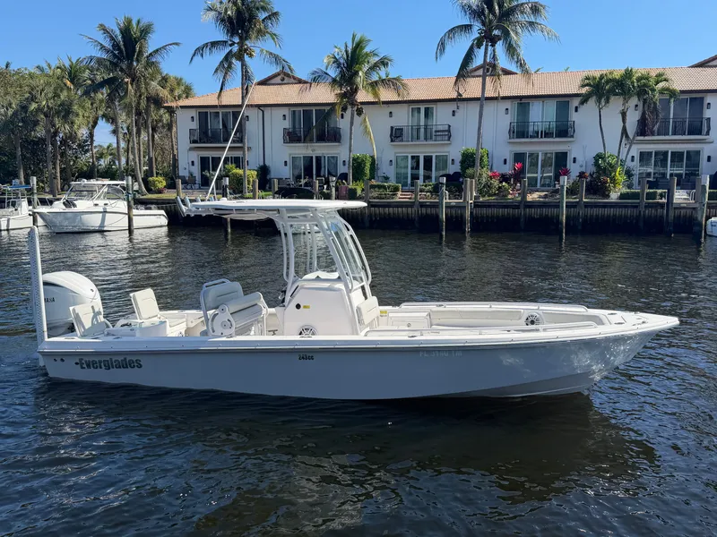 The Image of 2023 Everglades 243 Center Console boat near palm trees and houses. - 0