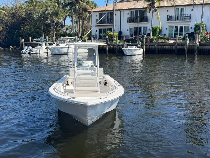Slide: The Image of Everglades 243 Center Console 2023 near waterfront homes. - 3