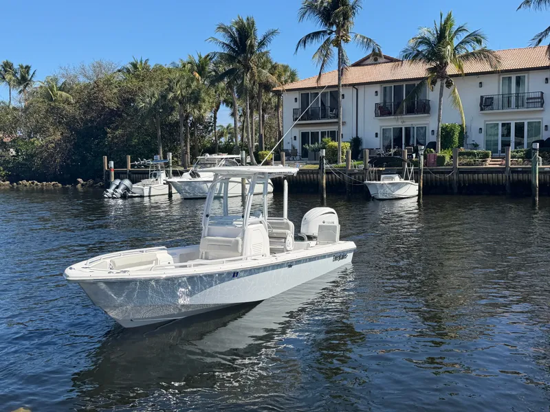 Slide: The Image of 2023 Everglades 243 Center Console boat near waterfront house. - 4