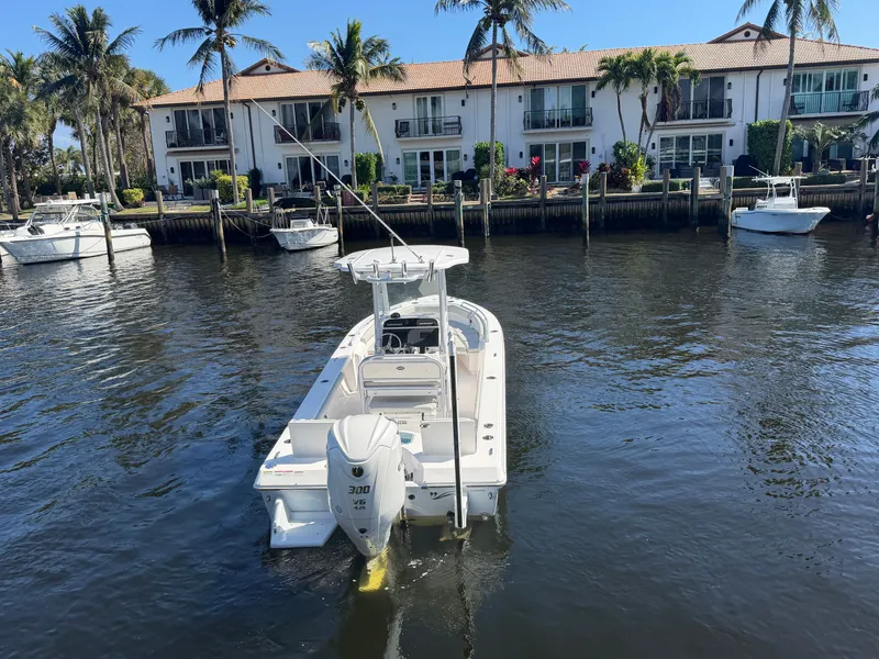 Slide: The Image of 2023 Everglades 243 Center Console boat on water near houses. - 6
