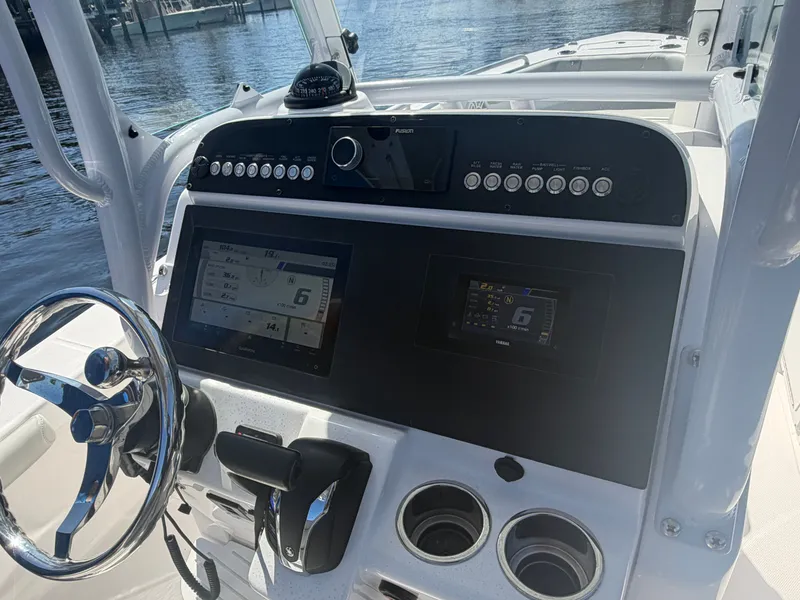 Slide: The Image of 2023 Everglades 243 Center Console boat dashboard with modern instruments. - 8
