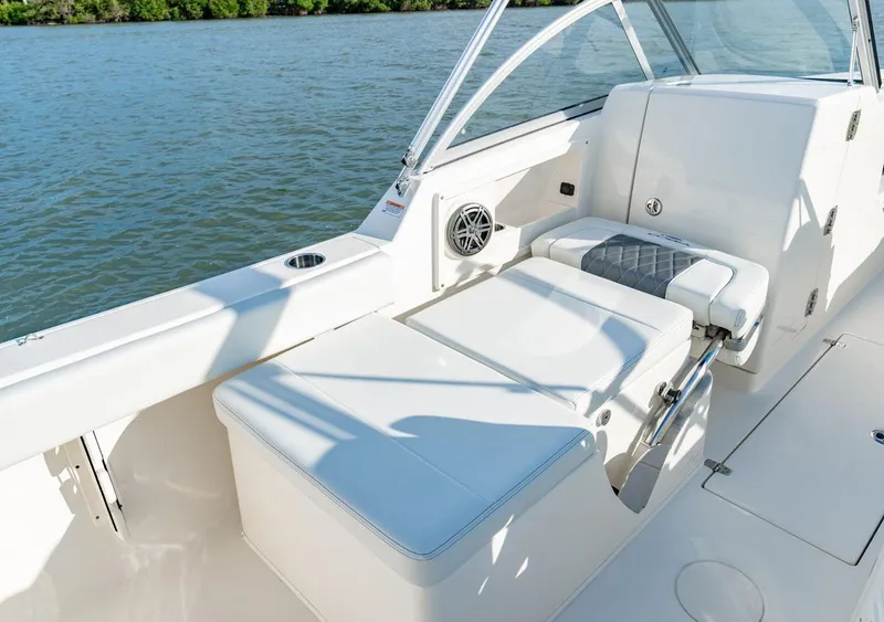 Slide: The Image of Manufacturer Provided Image: 2025 Cobia 220 Dual Console boat interior with seating and water view. - 11
