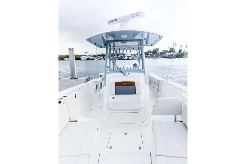 Slide: The Image of Manufacturer Provided Image: 2025 Cobia 320 Center Console boat docked by the water. - 10
