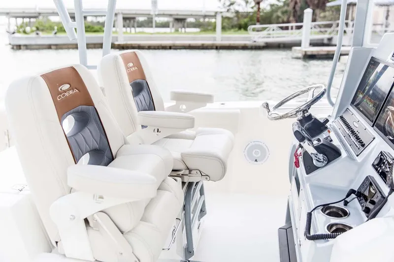 Slide: The Image of Manufacturer Provided Image: 2025 Cobia 320 Center Console boat interior with luxurious seating and modern dashboard. - 13