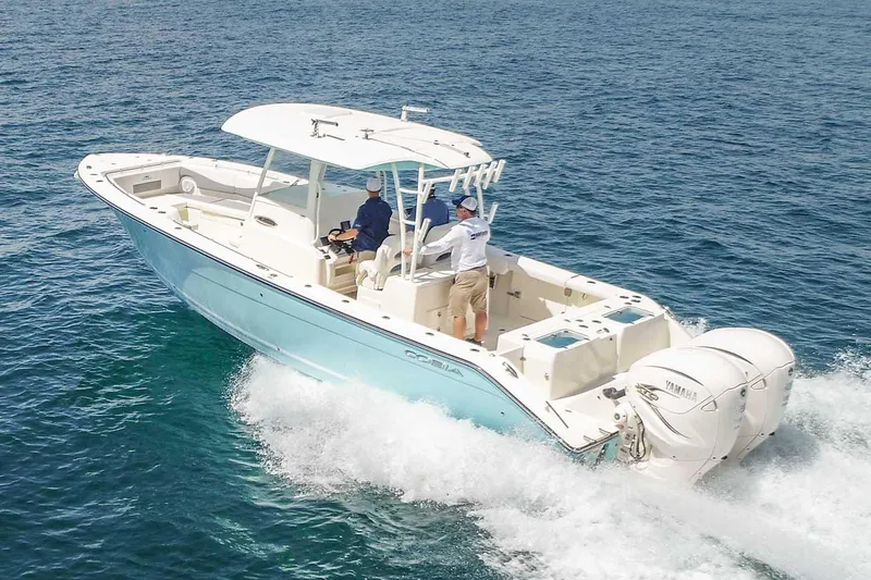 Slide: The Image of Manufacturer Provided Image: 2025 Cobia 320 Center Console boat cruising on open water. - 3