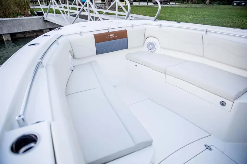 Slide: The Image of Manufacturer Provided Image: 2025 Cobia 320 Center Console boat interior with white seating and speaker. - 8