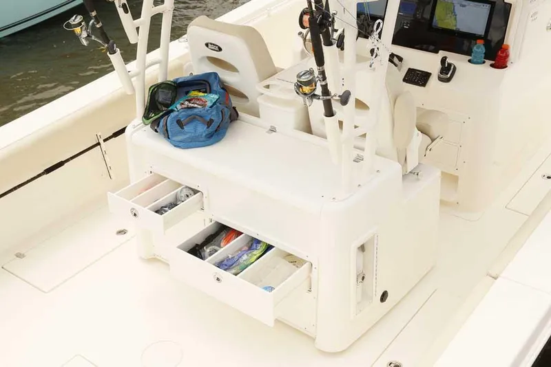 Slide: The Image of Manufacturer Provided Image: 2025 Cobia 350 Center Console boat interior with fishing gear and storage drawers. - 14