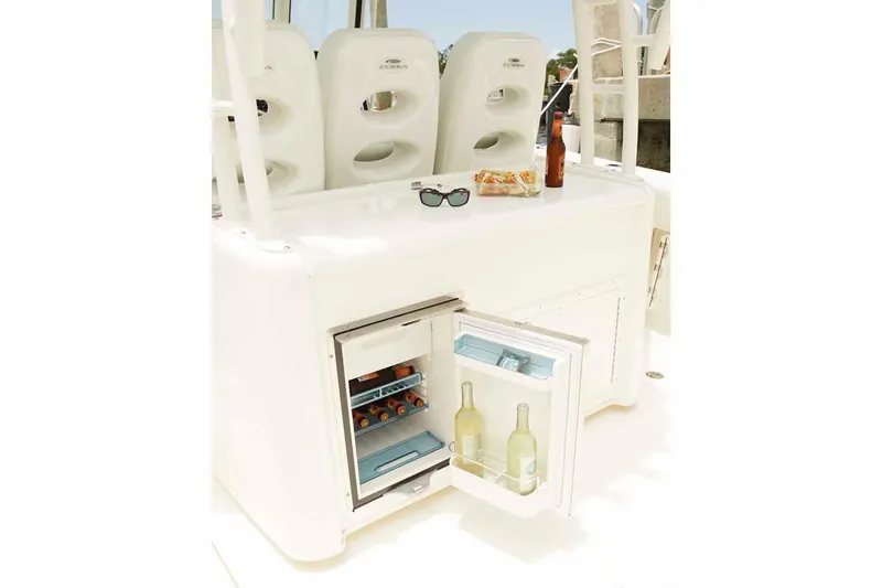 Slide: The Image of Manufacturer Provided Image: 2025 Cobia 350 Center Console with open mini fridge and refreshments. - 15