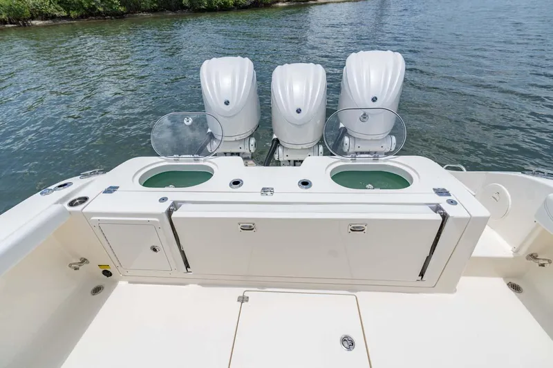 Slide: The Image of Manufacturer Provided Image: 2025 Cobia 350 Center Console with triple engines on calm water. - 16