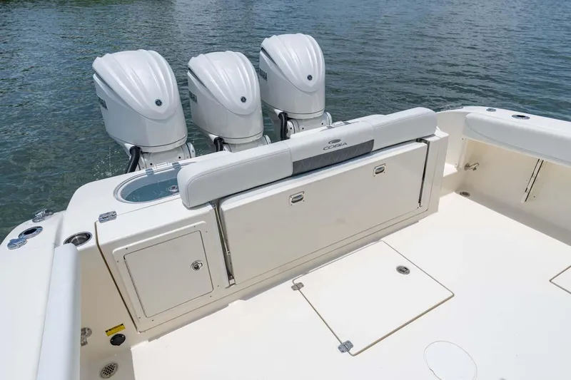 Slide: The Image of Manufacturer Provided Image: 2025 Cobia 350 Center Console boat with triple outboard engines on water. - 17