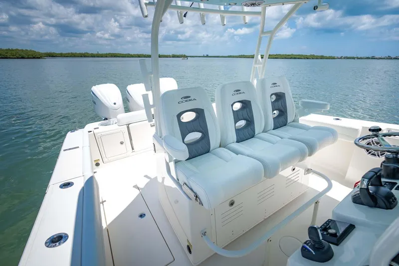 Slide: The Image of Manufacturer Provided Image: 2025 Cobia 350 Center Console boat with triple seating on calm water. - 19