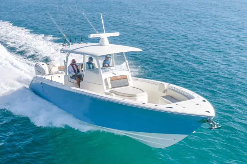 Slide: The Image of Manufacturer Provided Image: 2025 Cobia 350 Center Console boat cruising on open water. - 2