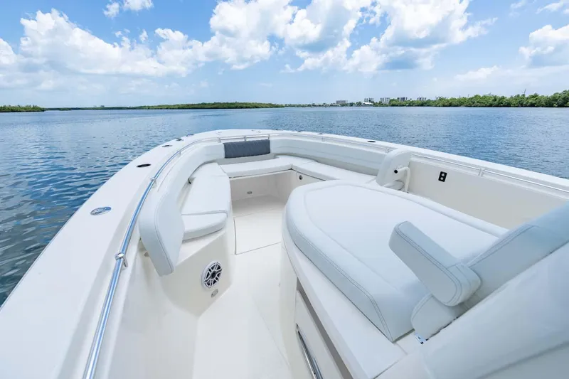 Slide: The Image of Manufacturer Provided Image: 2025 Cobia 350 Center Console boat on calm water under a blue sky. - 5