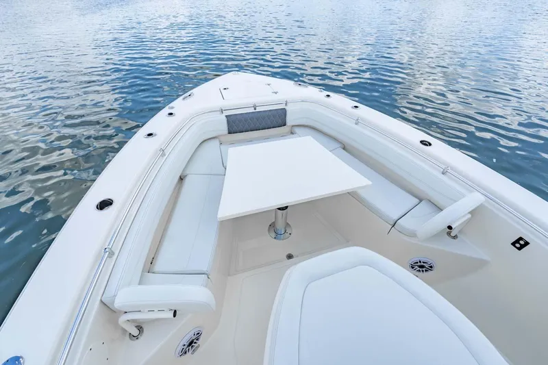 Slide: The Image of Manufacturer Provided Image: 2025 Cobia 350 Center Console boat with spacious seating and table on calm water. - 6