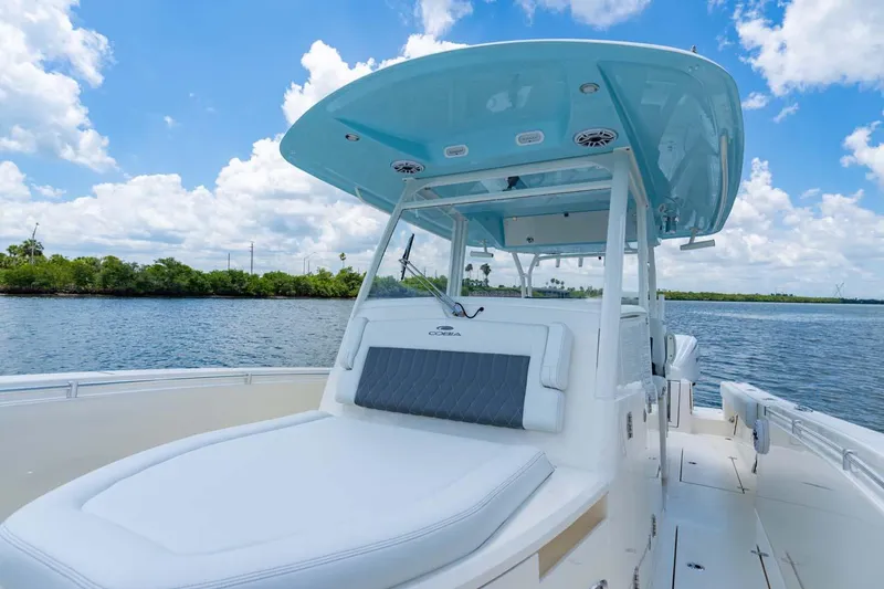 Slide: The Image of Manufacturer Provided Image: 2025 Cobia 350 Center Console boat on a sunny day, featuring sleek design and spacious deck. - 7