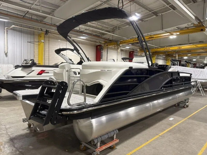 Slide: The Image of 2026 Bennington 25RTFB pontoon boat in a warehouse. - 15