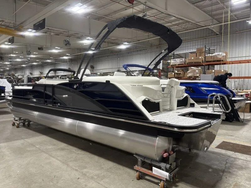 Slide: The Image of 2026 Bennington 25RTFB pontoon boat in a warehouse. - 6